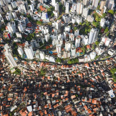 Aerial view of skyscrapers alongside small houses.